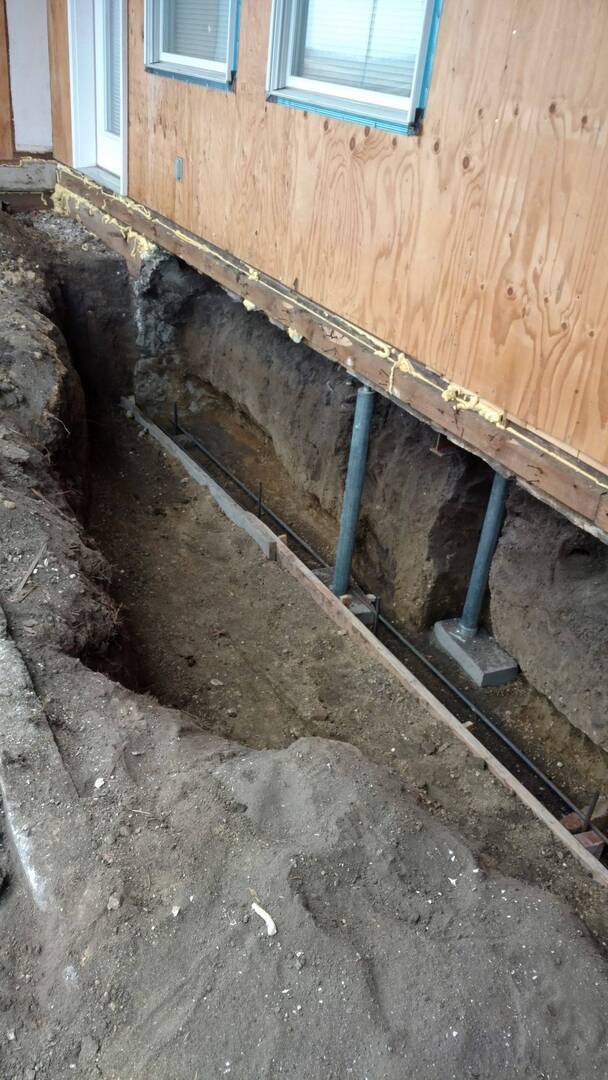 A picture of the Elkhart farmhouse crawlspace foundation after the existing foundation was removed and the ground was excavated.